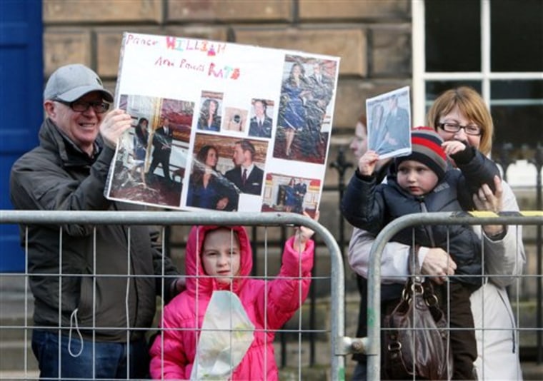 Members of the public are seen with banners for Kate Middleton and Prince William for their visit to St Andrews, Scotland. Friday, Feb, 25, 2011. (AP Photo/Scott Heppell)